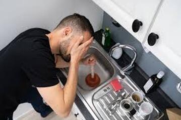 upset man with clogged sink